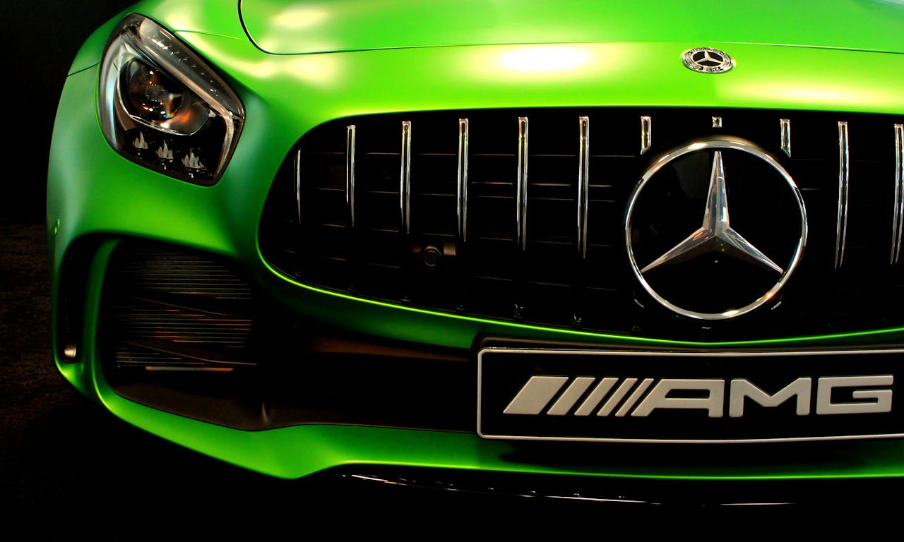 services-02 Close-up of a vibrant green Mercedes AMG grille showcasing the sleek design.
